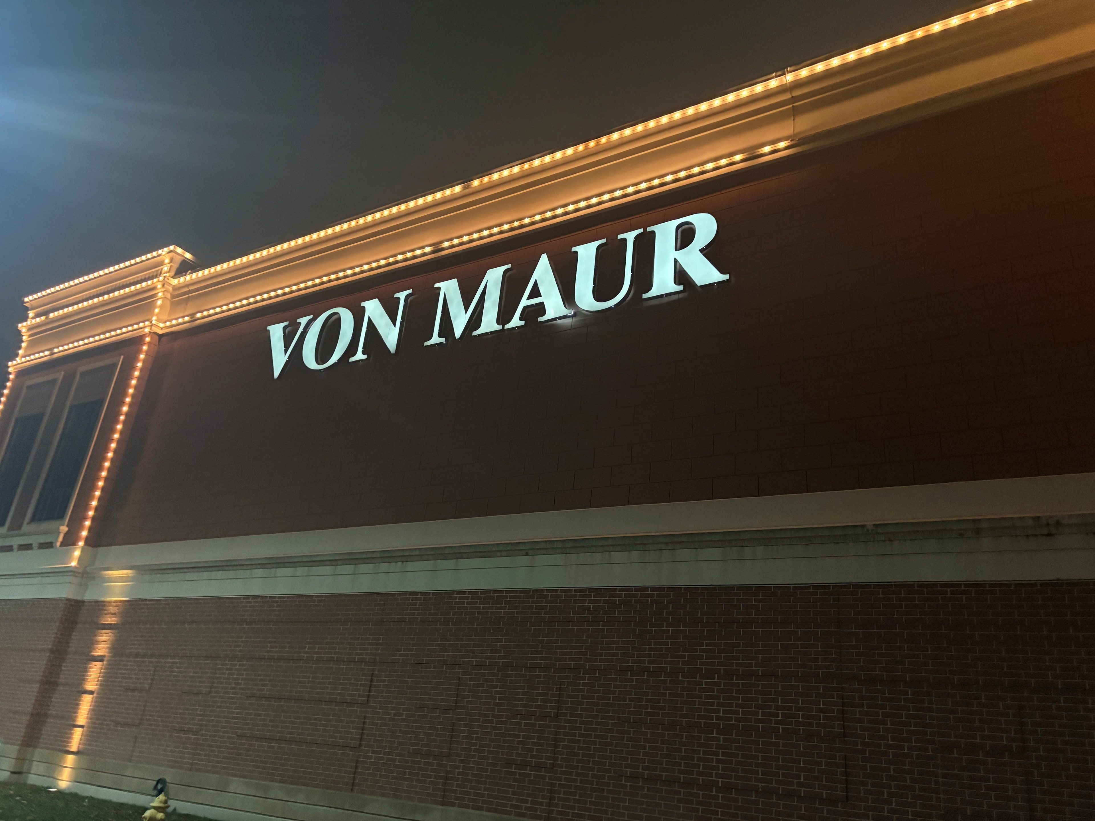 Von Maur wall sign framed by restored warm-white façade lighting