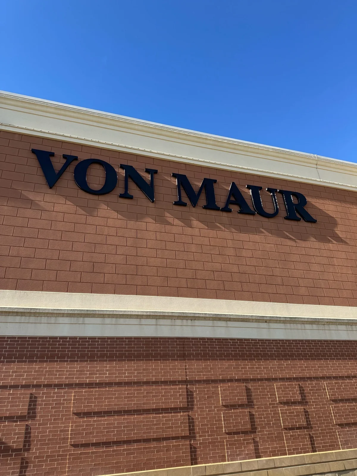 Completed Von Maur exterior sign beneath the permanent roofline lighting