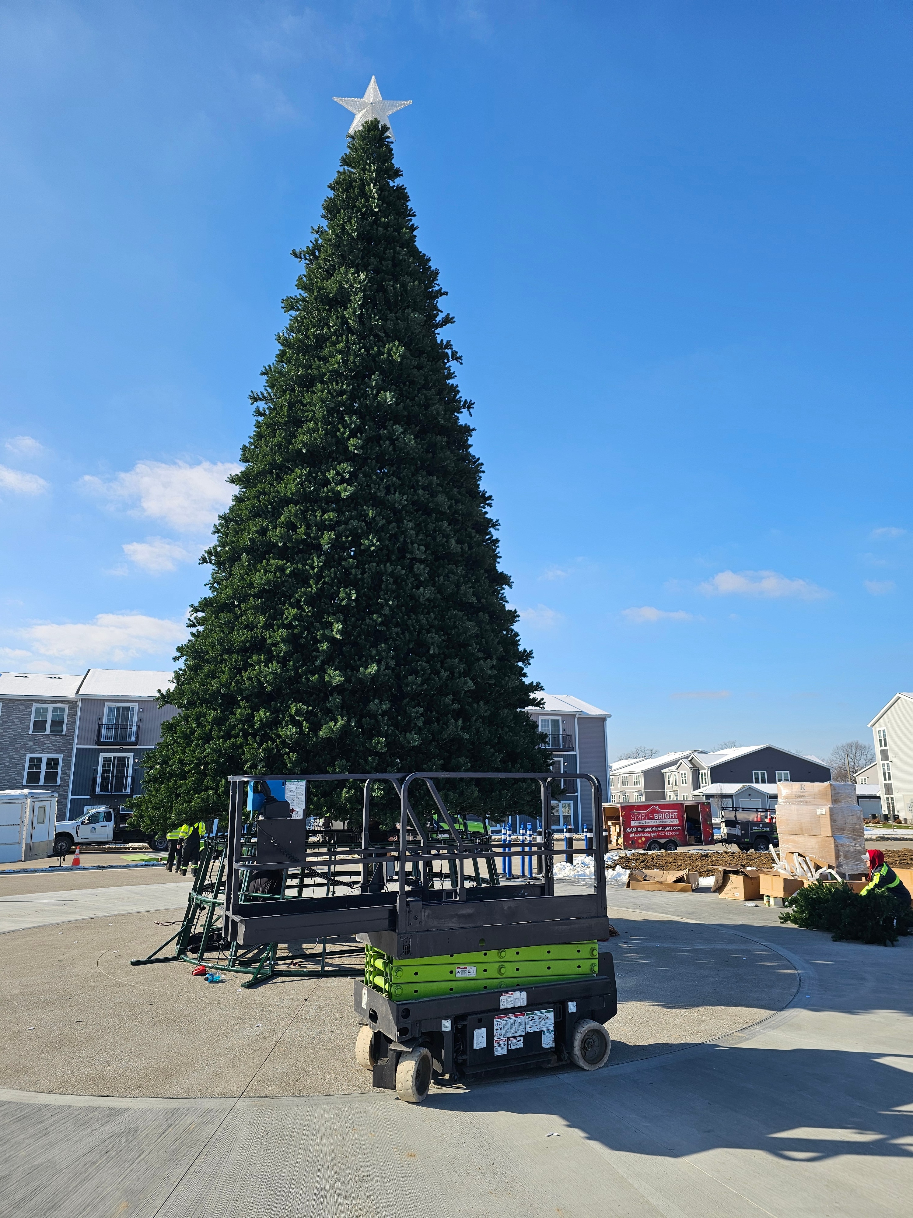 Completed artificial Christmas tree during daytime installation work