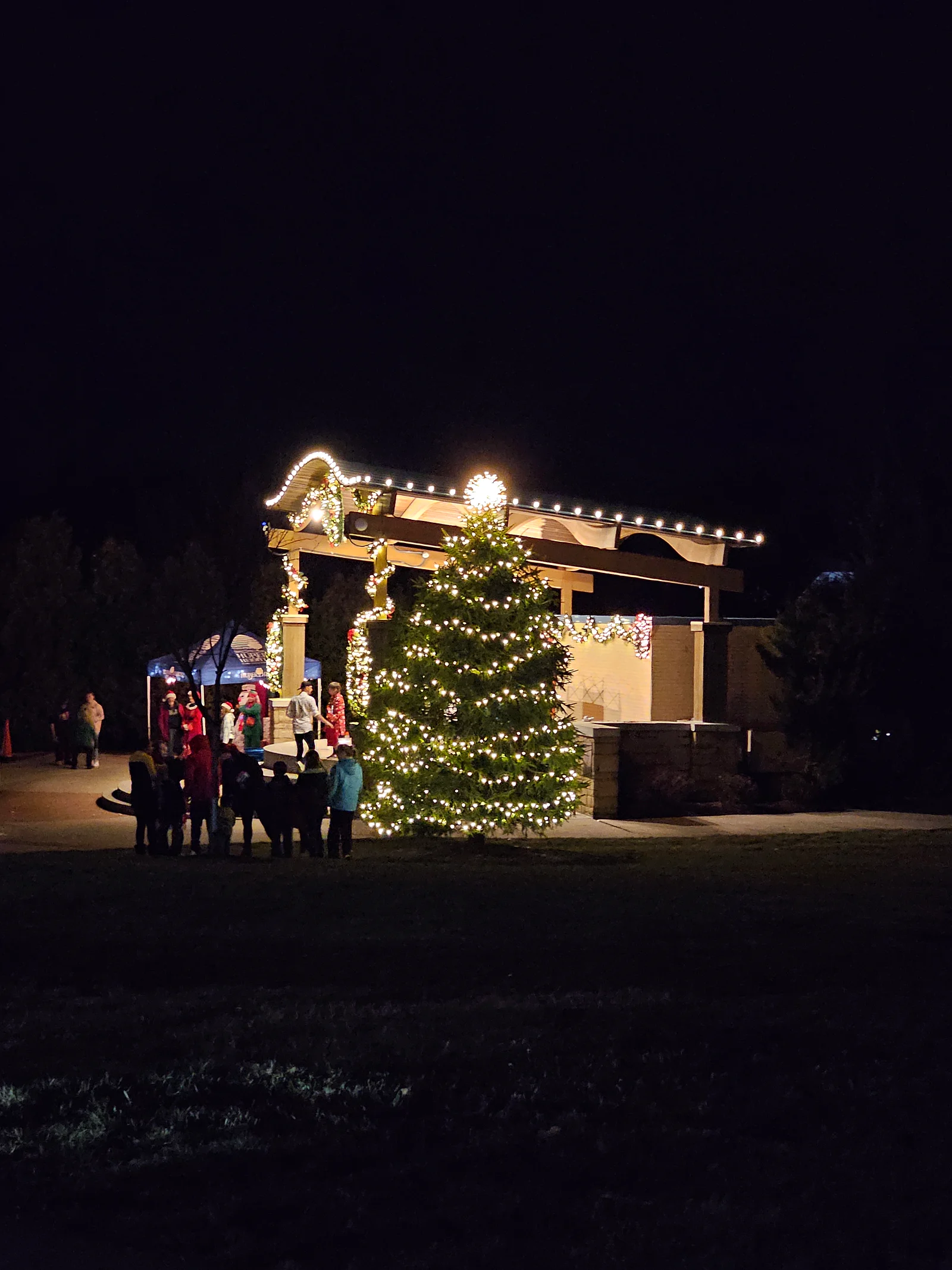 Huber Heights residents gathered around a decorated Christmas tree and illuminated pavilion in 2023