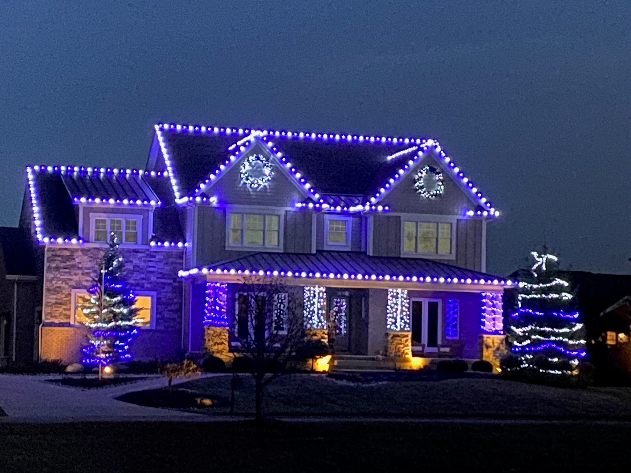 Centerville home illuminated in an icy blue-and-white Winter Frost color scheme